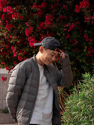 Harrison in front of some bougainvillea